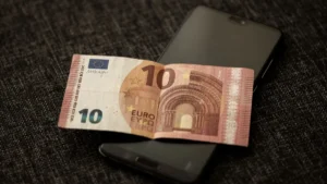 Cuentas nómina: billete de 10 euros sobre un teléfono móvil